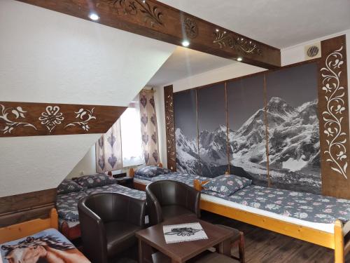 a room with two beds and a table at Pokoje Gościnne U Moniki i Daniela in Zakopane