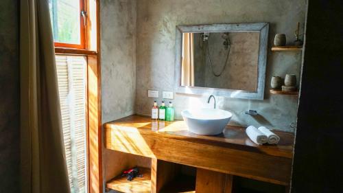 a bathroom with a sink and a mirror at Happiness Vacation Villa El Nido in El Nido
