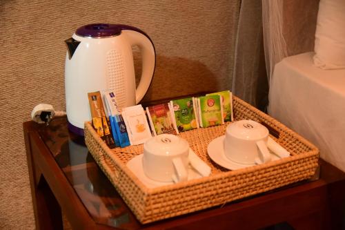 a wicker tray with a tea set on a table at Villa Sunny Days in Hikkaduwa