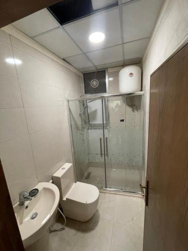 a bathroom with a shower and a toilet and a sink at Apartment for rent 50M fully furnished -completely new in Amman