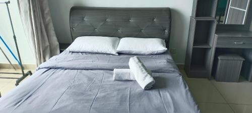 a bedroom with a bed with two pillows on it at Peacehome 31 in Cyberjaya