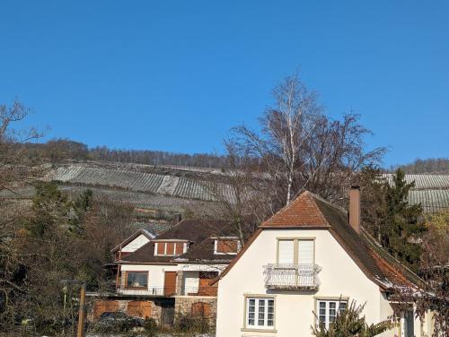 a white house with a balcony on top of it at Le Cosy (20' Strasbourg en Bus) in Marlenheim