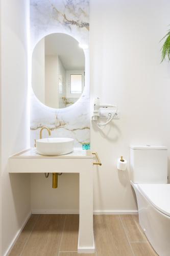 a white bathroom with a sink and a mirror at Butan Suite by Olax Rentals in Callao Salvaje