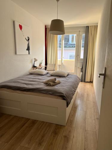 a dog laying on a bed in a bedroom at Cool & Central 2 bedroom in heart of Eaux-vives in Geneva