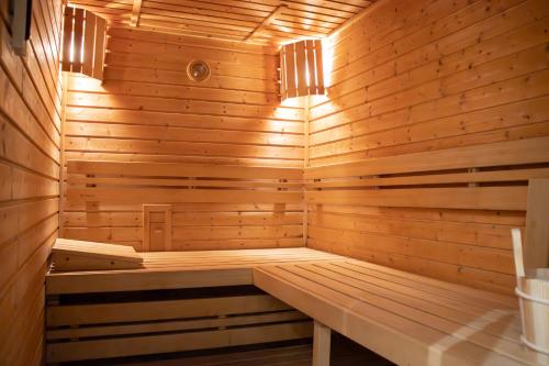 a wooden sauna with a bench in it at Hotel Villa Lauretta in Karlovy Vary