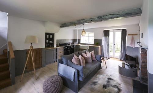 a living room with a couch and a kitchen at Salt in Sharrington