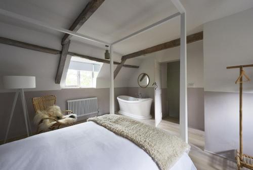 a bedroom with a white bed and a sink at Salt in Sharrington