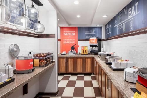 a restaurant kitchen with a counter with food at Hampton Inn Joliet-Plainfield I-55 in Joliet