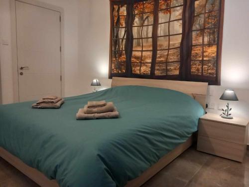 a bedroom with a bed with two towels on it at Apartment in Marsaskala in Marsaskala