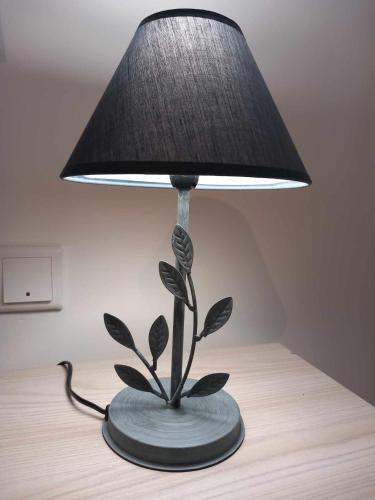 a lamp with a plant on a table at Apartment in Marsaskala in Marsaskala