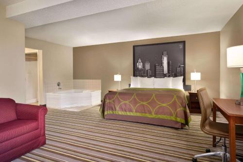 a hotel room with a bed and a desk at Super 8 by Wyndham Chambersburg I-81 in Chambersburg