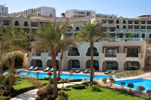 an aerial view of the resort with palm trees and a swimming pool at Sunrise Arabian Beach Resort in Sharm El Sheikh