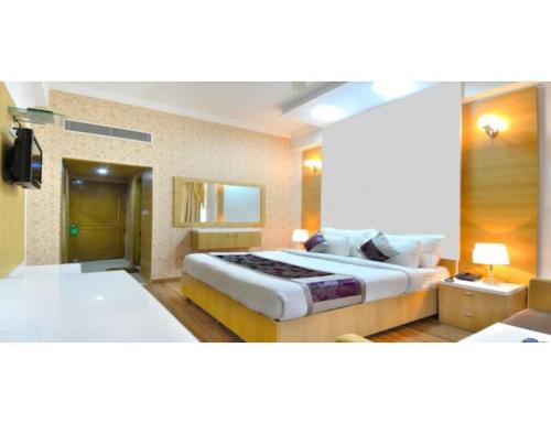 a hotel room with two beds and a television at Hotel Solitaire, Chandigarh in Chandīgarh