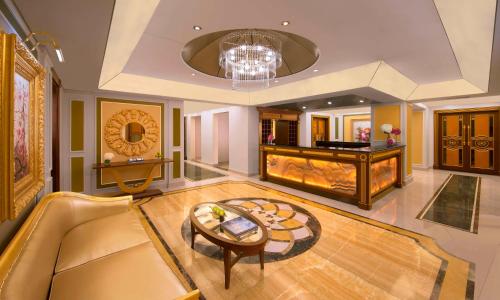a living room with a couch and a table at Royal Rose Abu Dhabi, a Curio Collection by Hilton Affiliated Hotel in Abu Dhabi