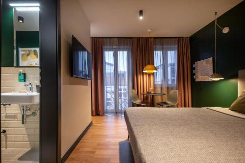 a bedroom with a bed and a sink and a bathroom at ipartment Berlin Mitte in Berlin