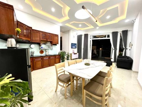 a kitchen and dining room with a table and chairs at CT Villa in Xuan An