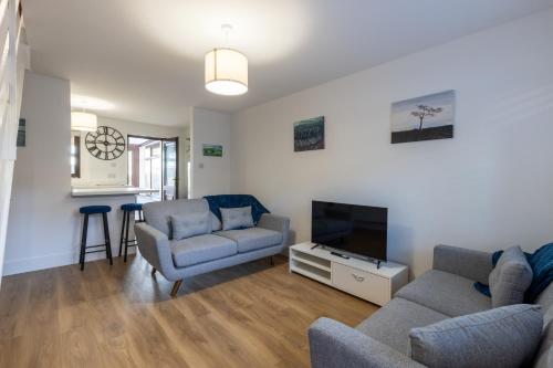 a living room with a couch and a tv at Orchard House - 2 bedroom house, Central Alnwick in Alnwick