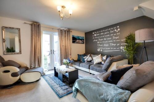 a living room with couches and a chalkboard wall at Runcorn - House - Sleeps 6 - Parking - Garden in Runcorn