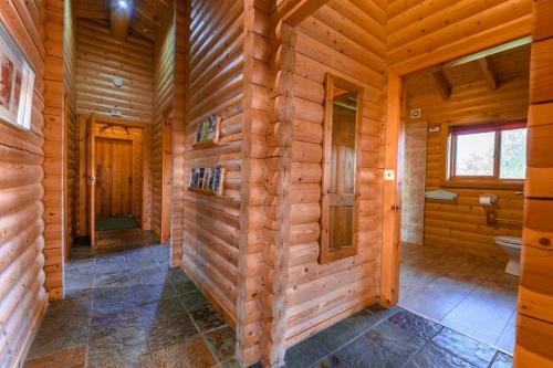 a log cabin bathroom with a toilet and a window at Pinecroft Lodges in Ingleton 