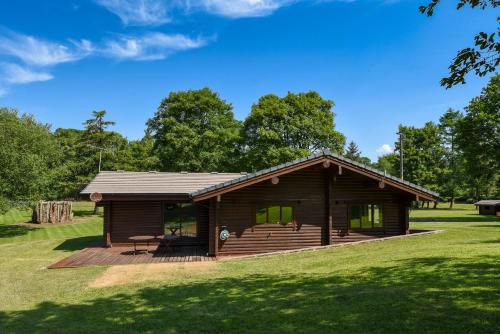 a small cabin with a deck in a park at Pinecroft Lodges in Ingleton 