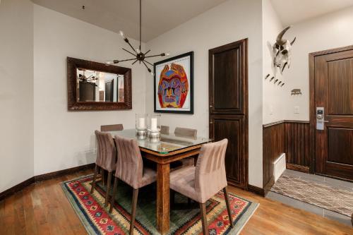 a dining room with a table and chairs and a mirror at LIFT LODGE 102 condo in Park City