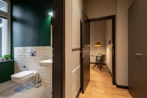 a bathroom with a toilet and a sink at ipartment Berlin Mitte in Berlin