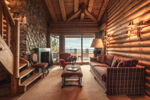 a living room with a couch and a tv at LeCrans in Crans-Montana