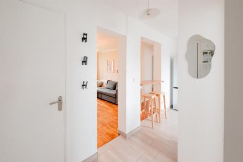 a white apartment with a sliding door leading to a living room at BonaBonheur in Toulouse