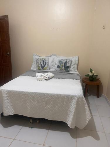 a bedroom with a bed with a white comforter at CASA PÔR DO SOl in Alter do Chao