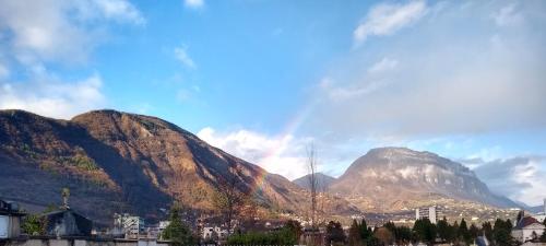 a view of a mountain with a city and buildings at Colocation proche fac de médecine in La Tronche