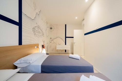 a bedroom with a bed with a map on the wall at ApartmentsGarda - L'Isola Blu in Garda