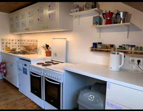 a kitchen with a stove and a counter top at Colocation proche fac de médecine in La Tronche