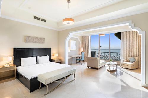 a bedroom with a bed and a living room at Al Hamra Residence in Ras al Khaimah
