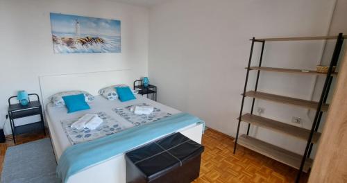 a bedroom with a bed with blue pillows and a ladder at Sea and mountain in Rijeka
