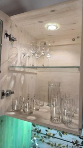 a bunch of glasses sitting on a shelf at Shanti Garden House in Dahab