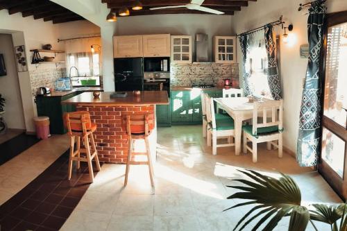 a kitchen with a table and chairs and a dining room at Shanti Garden House in Dahab
