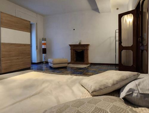 a bedroom with a large bed and a fireplace at La Famosa Dimora Ambasciatore in San Marino