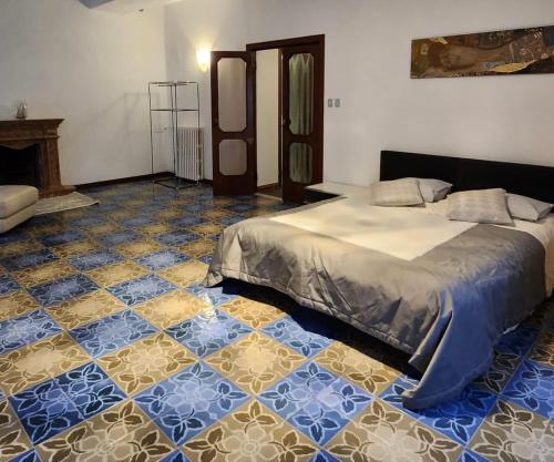 a bedroom with a bed and a tiled floor at La Famosa Dimora Ambasciatore in San Marino