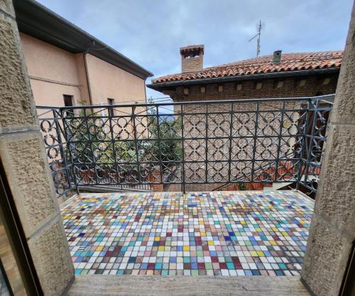 a balcony with a mosaic floor in front of a building at La Famosa Dimora Ambasciatore in San Marino