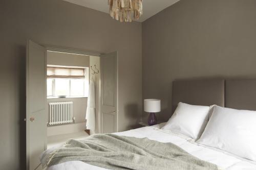 a bedroom with a white bed and a window at Shell in Sharrington