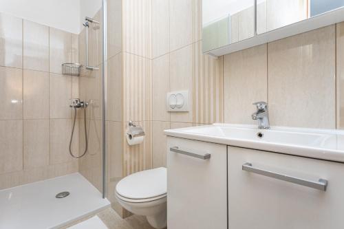 a bathroom with a sink and a toilet and a shower at B&B Villa Ana in Krk