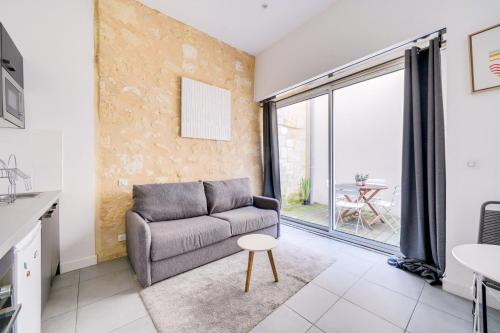 un salon avec un canapé et une table dans l'établissement Beautiful apartment Bordeaux with private terrace, à Bordeaux