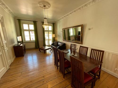 a dining room with a table and a couch at Honigmond Boutique Hotel in Berlin