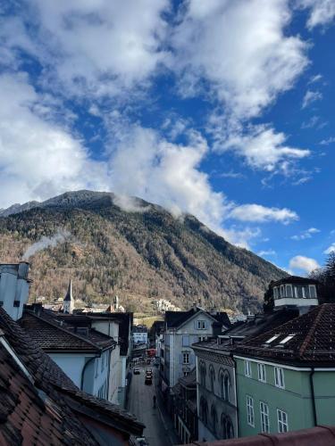 a view of a mountain from a city with buildings at Haus zum Rütli in Chur