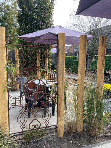 a table and chair with an umbrella on a patio at Holiday in Spakenburg Groof in Spakenburg