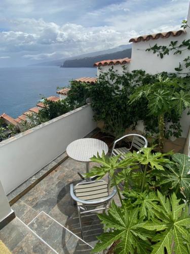 a patio with two chairs and a table on a balcony at Villa Oasis La Paz - Romen Studio - ADULTS ONLY in Puerto de la Cruz