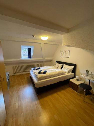 a bedroom with a large bed and a wooden floor at Haus zum Rütli in Chur