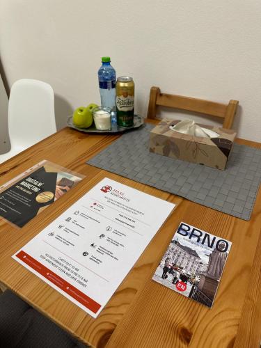 a table with a menu and a box on it at Haas Apartments Downtown with Parking in Brno