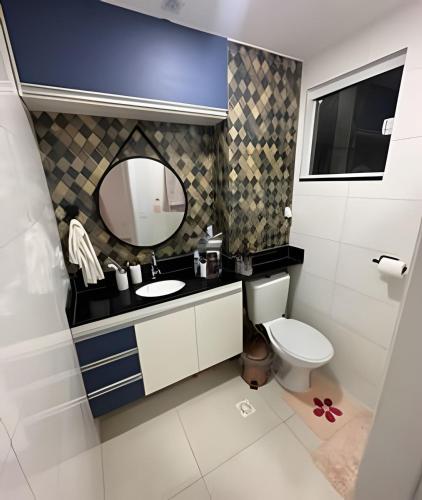 a bathroom with a toilet and a sink and a mirror at aconchegante apt de 1 dormitorio in Rio de Janeiro