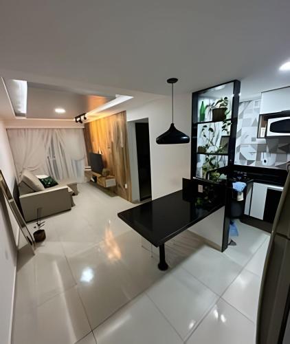 a living room with a black table and a couch at aconchegante apt de 1 dormitorio in Rio de Janeiro